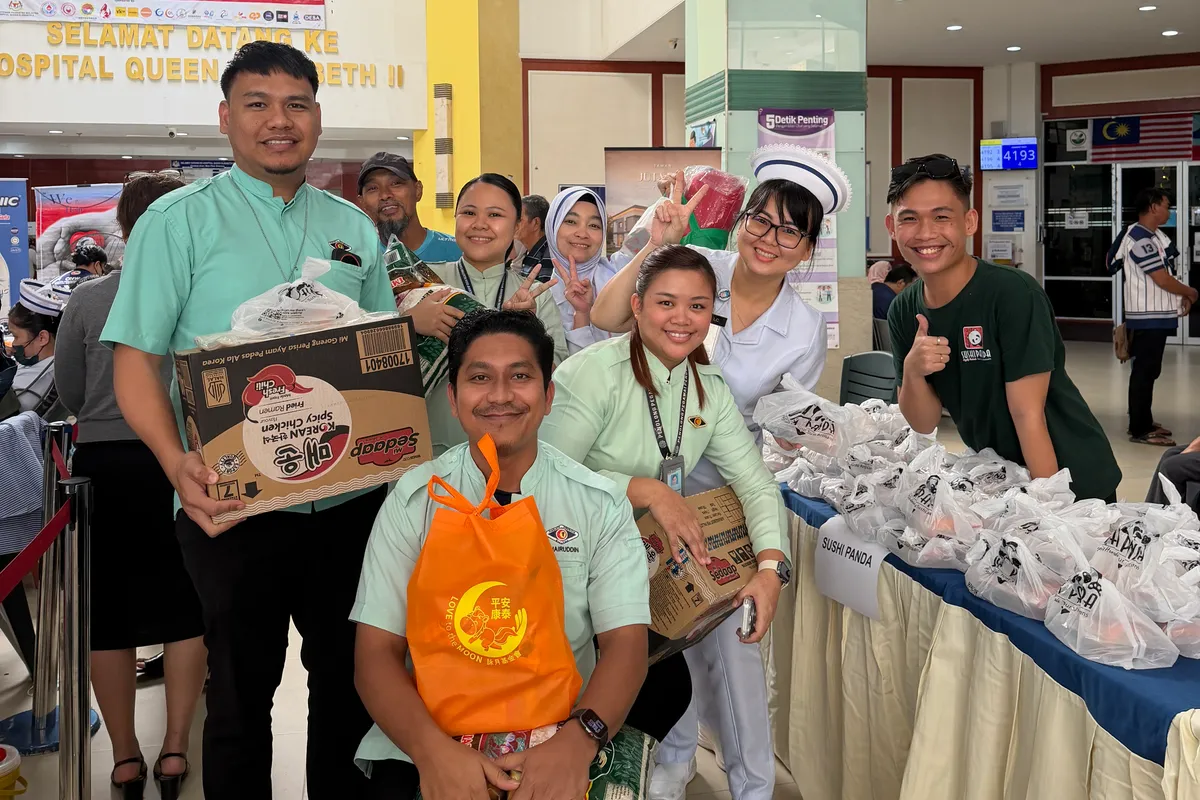 Our crew with hospital staff and volunteers at the Care Box table, Hospital Queen Elizabeth II