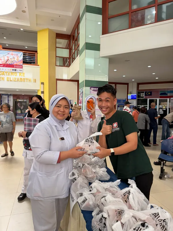 A nurse receives a Care Box from our crew at the hospital blood donation drive
